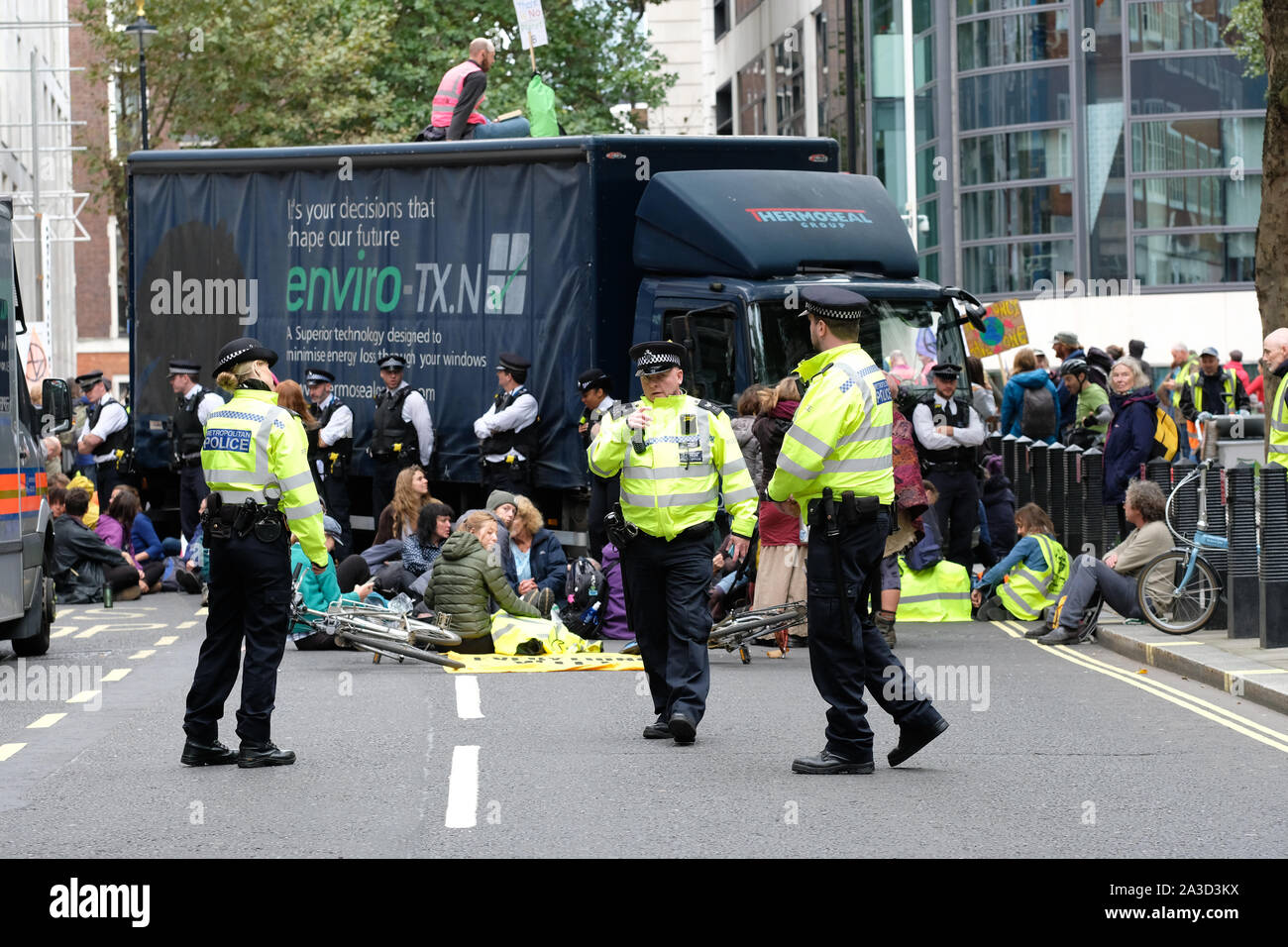 Westminster, London, UK - Monday 7th October 2019 - Police officers confer in front of the Extinction Rebellion XR climate protesters who have blocked block Marsham Street directly outisde the Home Office with a lorry. Photo Steven May / Alamy Live News Stock Photo