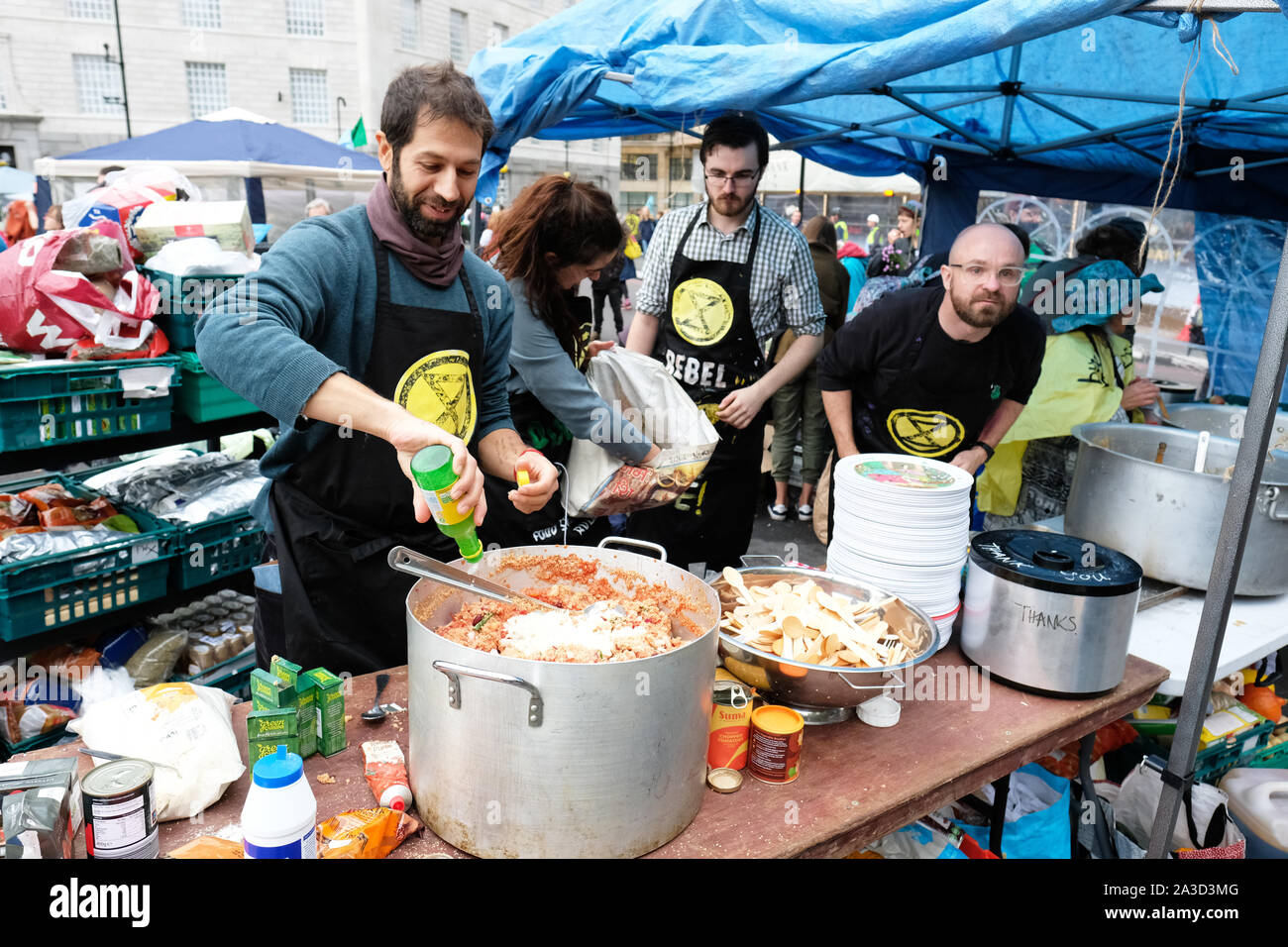 Westminster, London, UK - Monday 7th October 2019 - Extinction Rebellion XR climate protesters cook up food for their supporters at an impromptu field street kitchen beside Lambeth Bridge. Photo Steven May / Alamy Live News Stock Photo
