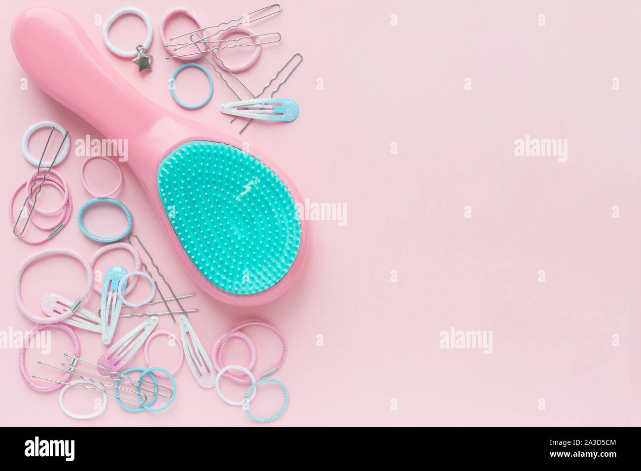 Hair scrunchies and hairpins, hairbrush on pink background, beauty concept. flat lay. free space for text Stock Photo