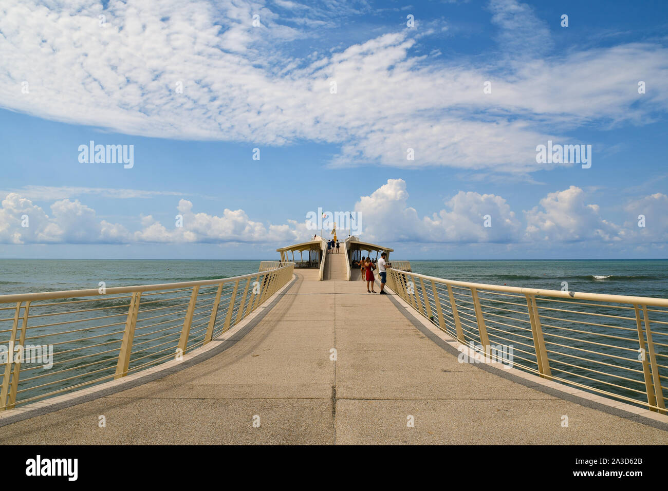 View of Pontile Bellavista Vittoria, a pier built in 2008, with tourists walking in a sunny summer day, Lido di Camaiore, Tuscany, Versilia, Italy Stock Photo