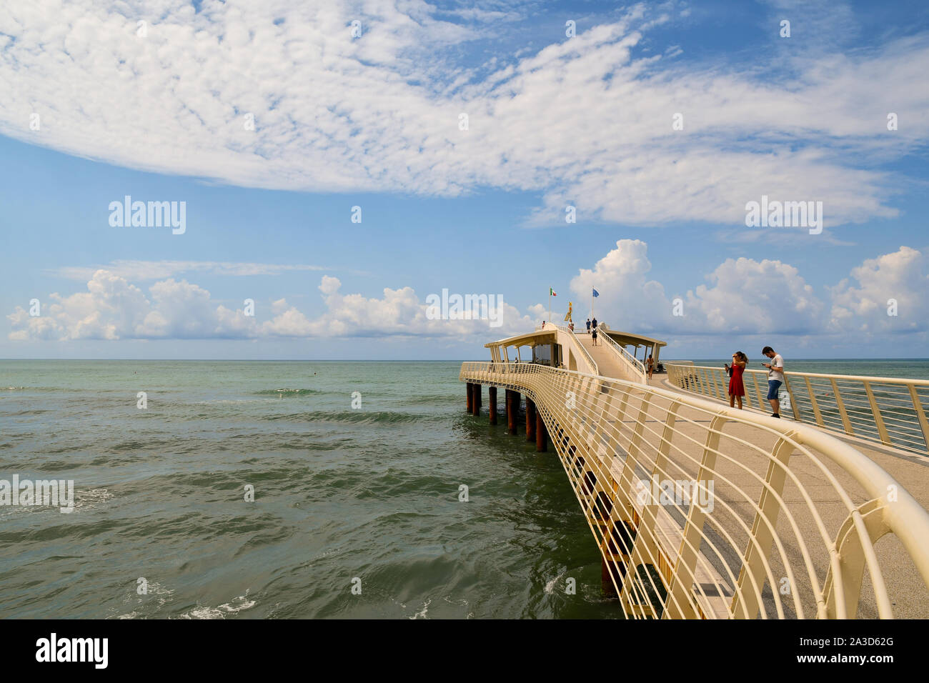 View of Pontile Bellavista Vittoria, a pier built in 2008, with tourists walking in a sunny summer day, Lido di Camaiore, Tuscany, Versilia, Italy Stock Photo