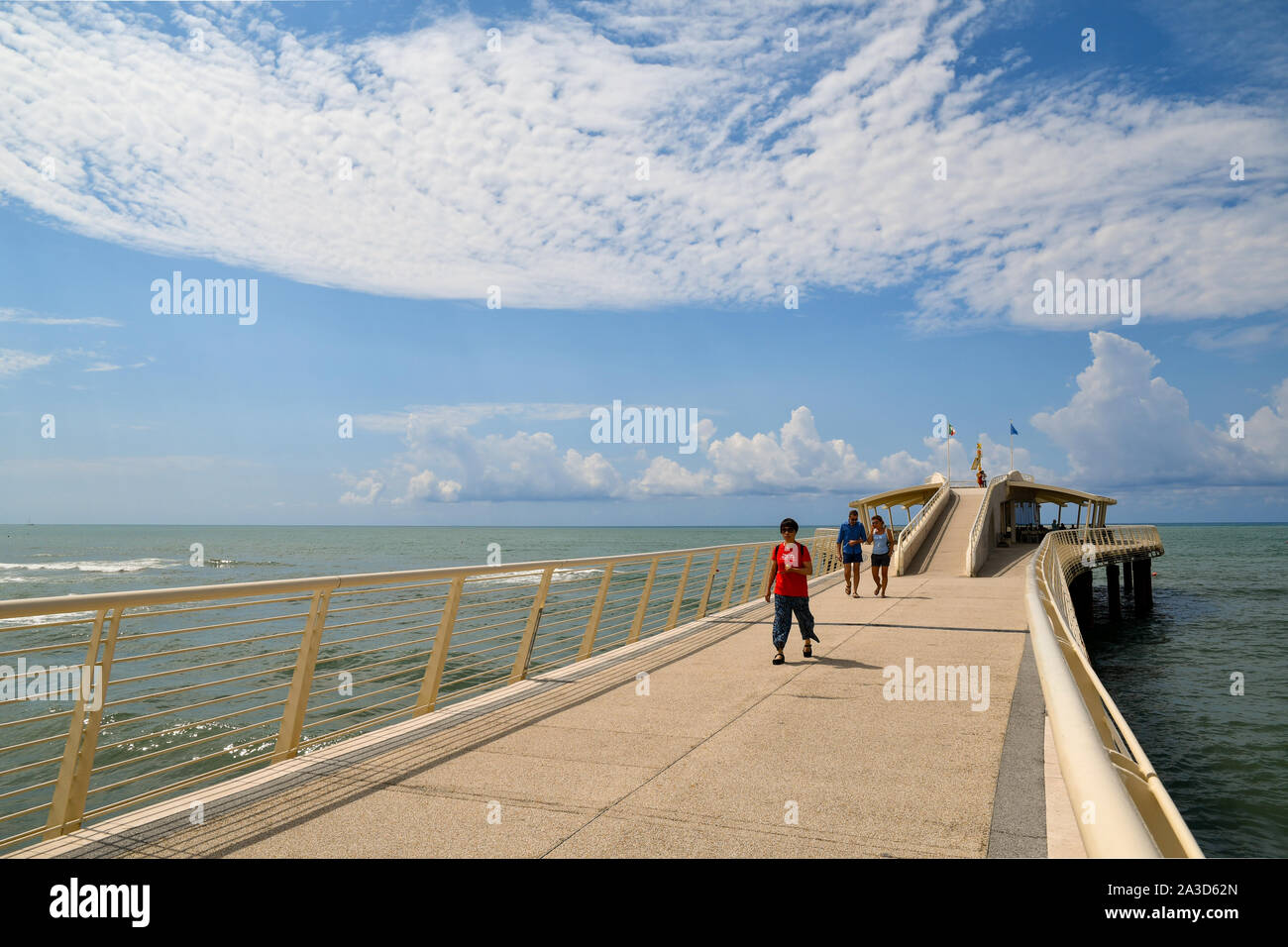 View of Pontile Bellavista Vittoria, a pier built in 2008, with tourists walking in a sunny summer day, Lido di Camaiore, Tuscany, Versilia, Italy Stock Photo