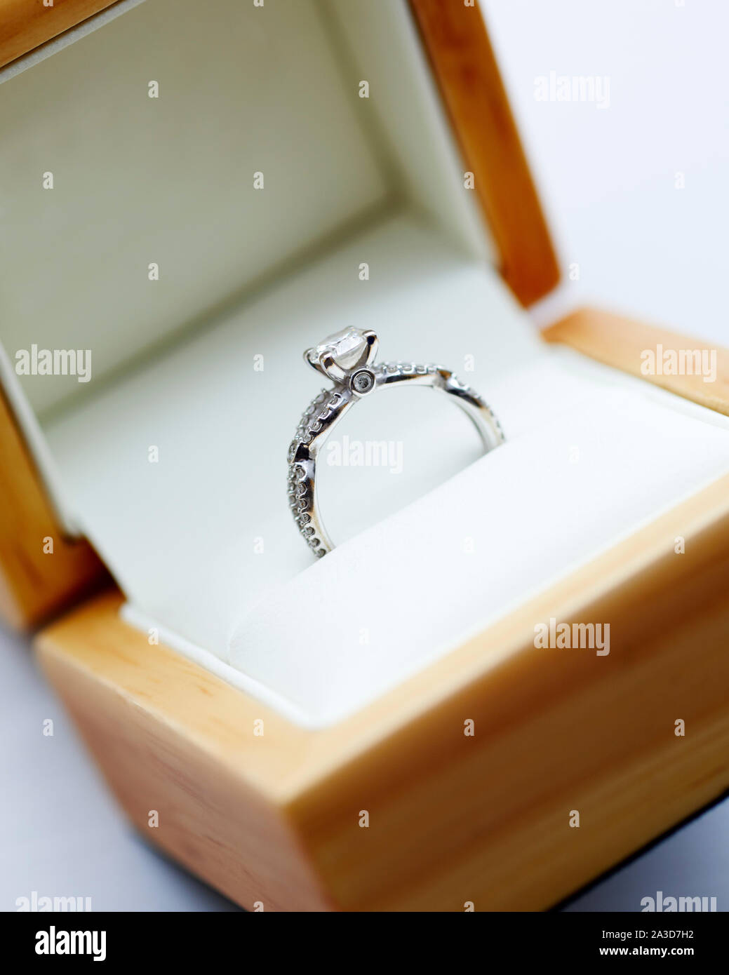 Diamond engagement ring in it's wooden display box Stock Photo