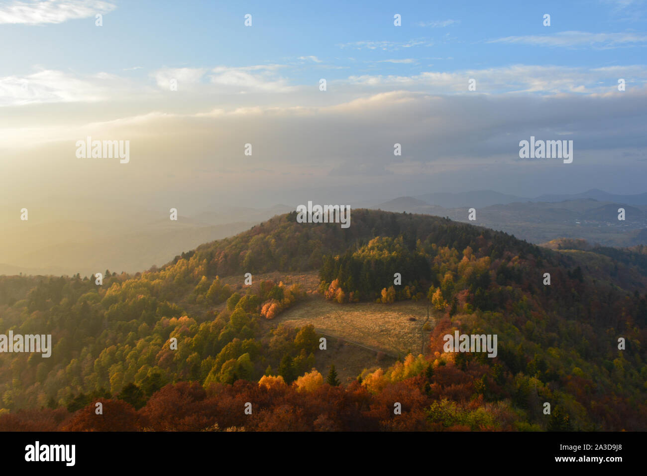 Colorful and beautiful view over the mountain and green forest. Panoramic autumn scene from a hiking trail in Slovakia. Fall in the woods Stock Photo