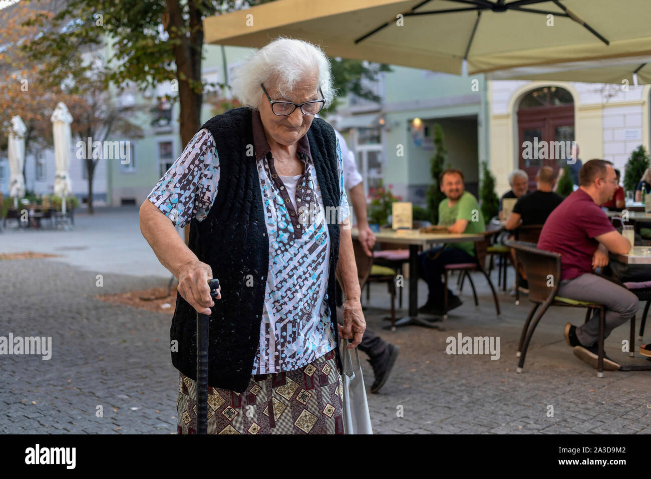 Old lady walking down the street hi-res stock photography and images ...