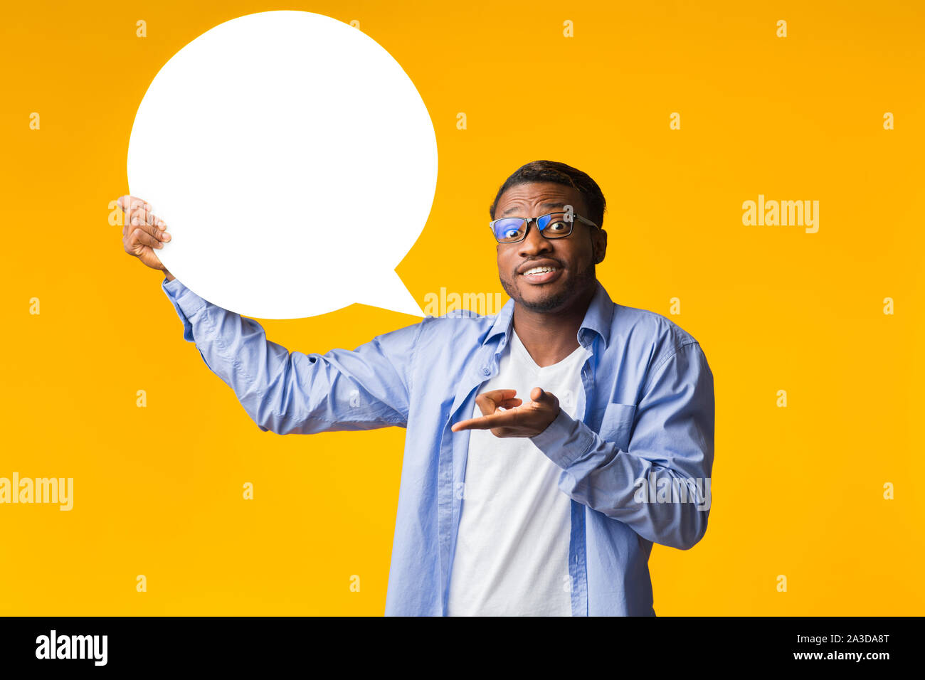 African American Man Holding Speech Bubble Standing Over Yellow Background Stock Photo