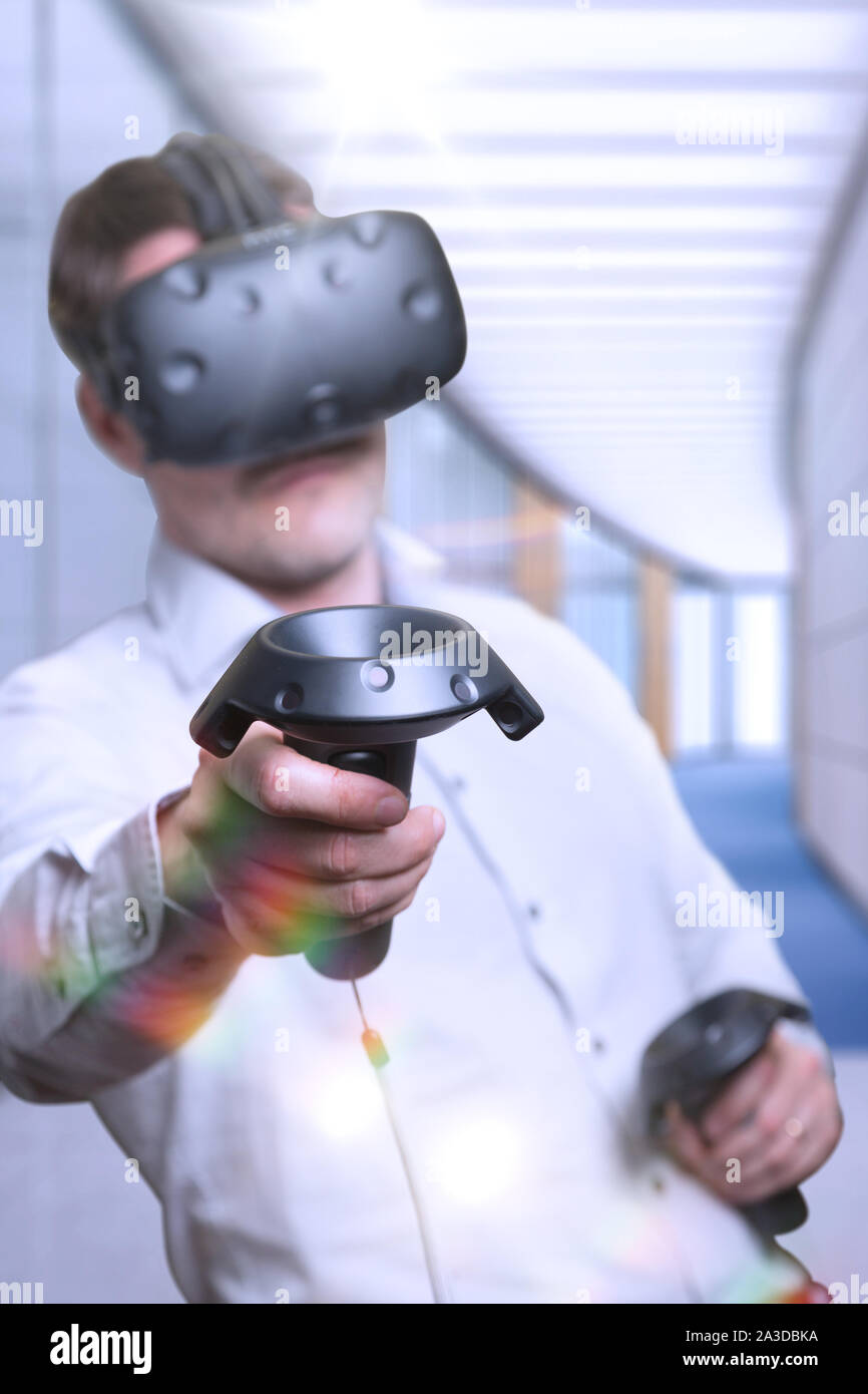 Man wearing a virtual reality headset and playing a game Stock Photo ...
