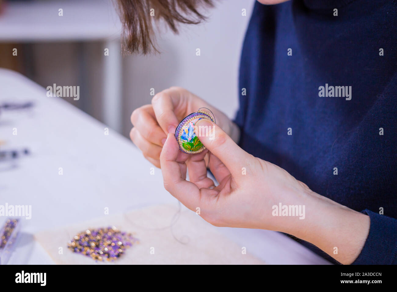 Designer making handmade brooch Stock Photo