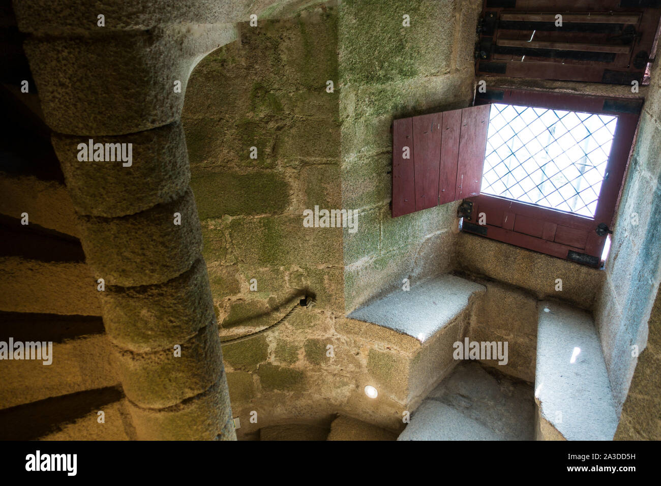 Stone spiral staircase / winding stairs and window seat in recess at Château de Tiffauges, medieval castle, Vendée, France Stock Photo