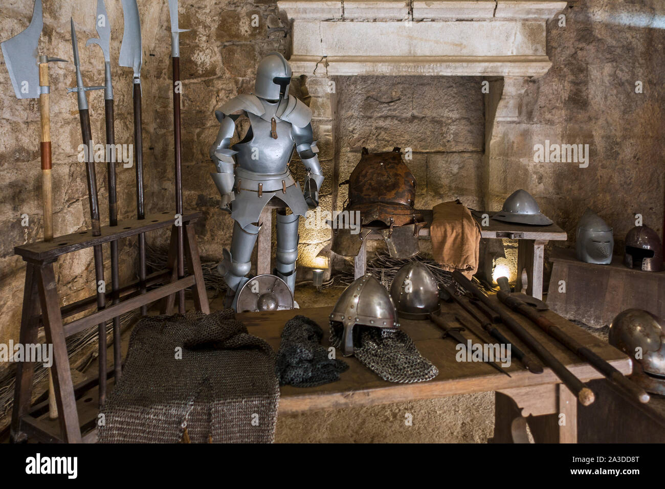 Suit of armour, halberds and weapons of the Middle Ages in armoury at the Château de Tiffauges, medieval castle, Vendée, France Stock Photo