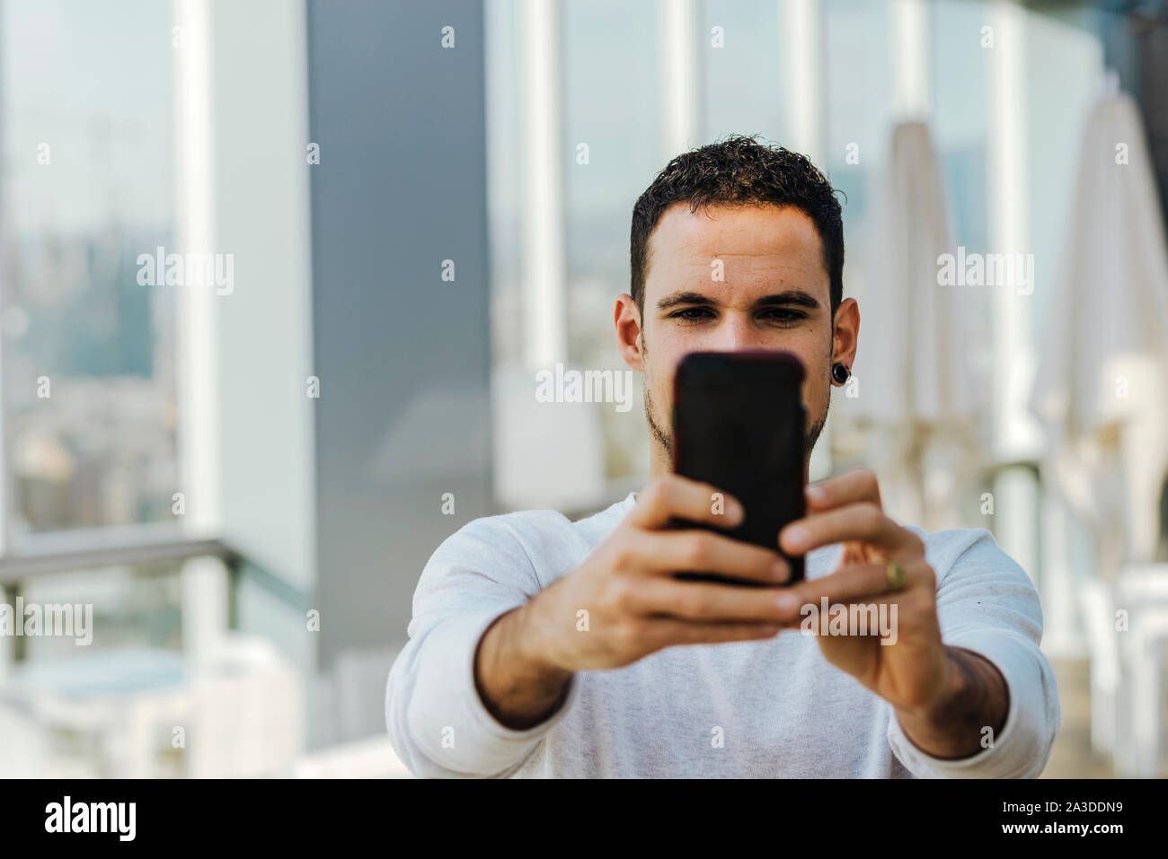 Young man taking a selfie with smartphone Stock Photo