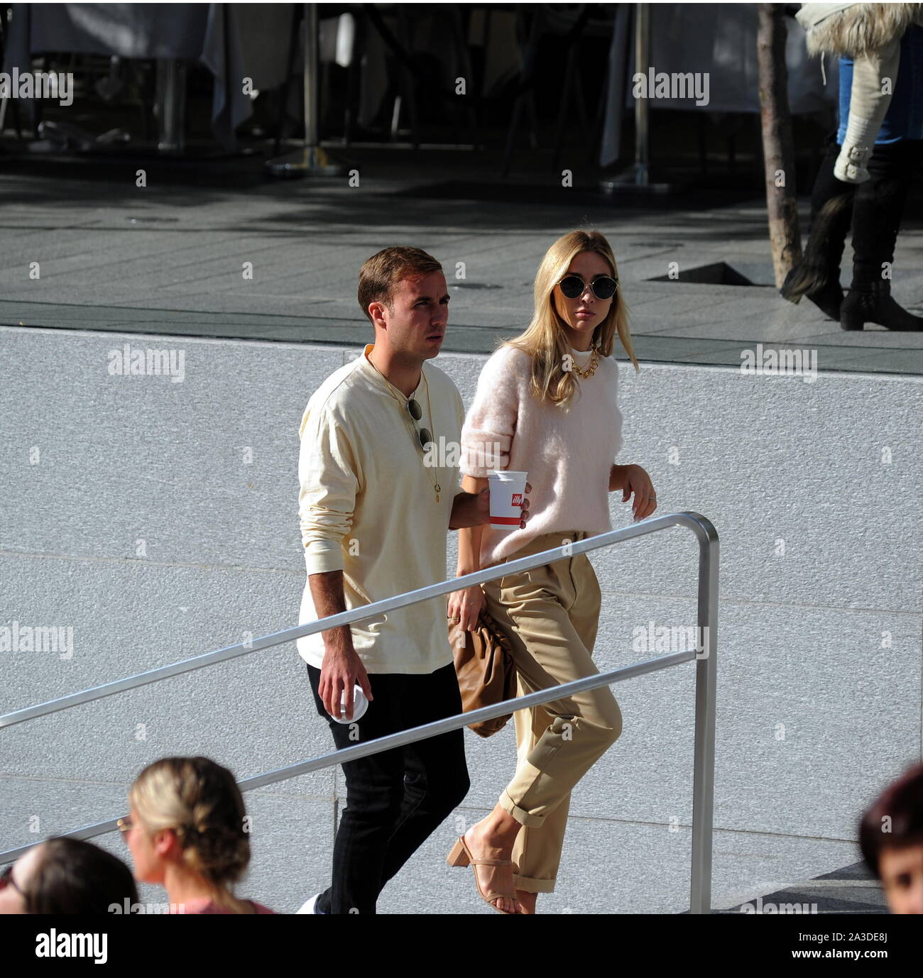 Milan, Mario Gotze and wife Ann Kathrin Brommel Mario Gotze, German footballer of BORUSSIA DORTMUND and of the national team of GERMANY, caught a glimpse of the streets of the center with his wife ANN KATHRIN BROMMEL. Here they go for a long walk along the streets of the quadrilateral, then a stop at the 'APPLE' store in Piazza Liberty, to try new smartphones, and a walk in Piazza Duomo before returning to the hotel. Stock Photo