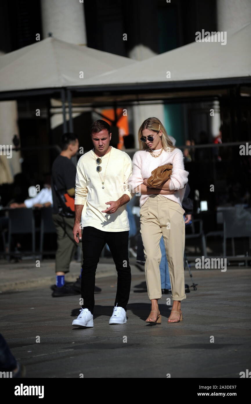 Milan, Mario Gotze and wife Ann Kathrin Brommel Mario Gotze, German footballer of BORUSSIA DORTMUND and of the national team of GERMANY, caught a glimpse of the streets of the center with his wife ANN KATHRIN BROMMEL. Here they go for a long walk along the streets of the quadrilateral, then a stop at the 'APPLE' store in Piazza Liberty, to try new smartphones, and a walk in Piazza Duomo before returning to the hotel. Stock Photo