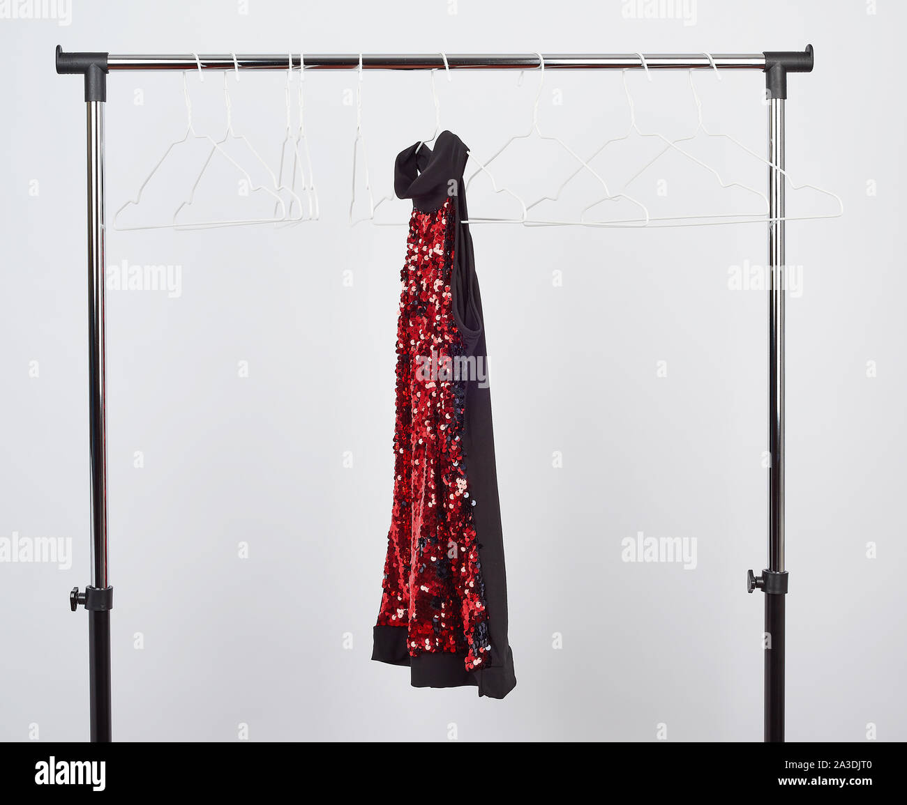 black women's blouse with red sequins hanging on a white iron hanger ...
