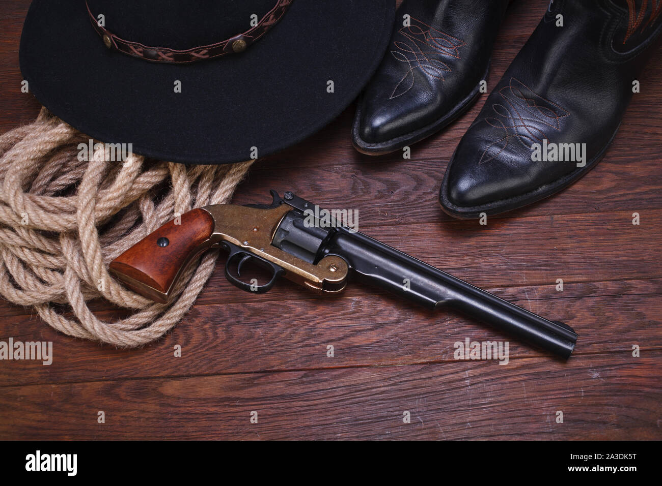 Old western gun with hat, rope and boots Stock Photo - Alamy