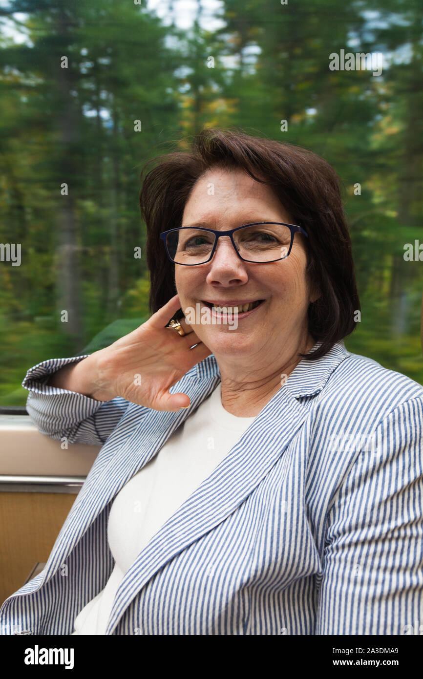 Female passenger enjoying the Rocky Mountaineer tourist train ride from