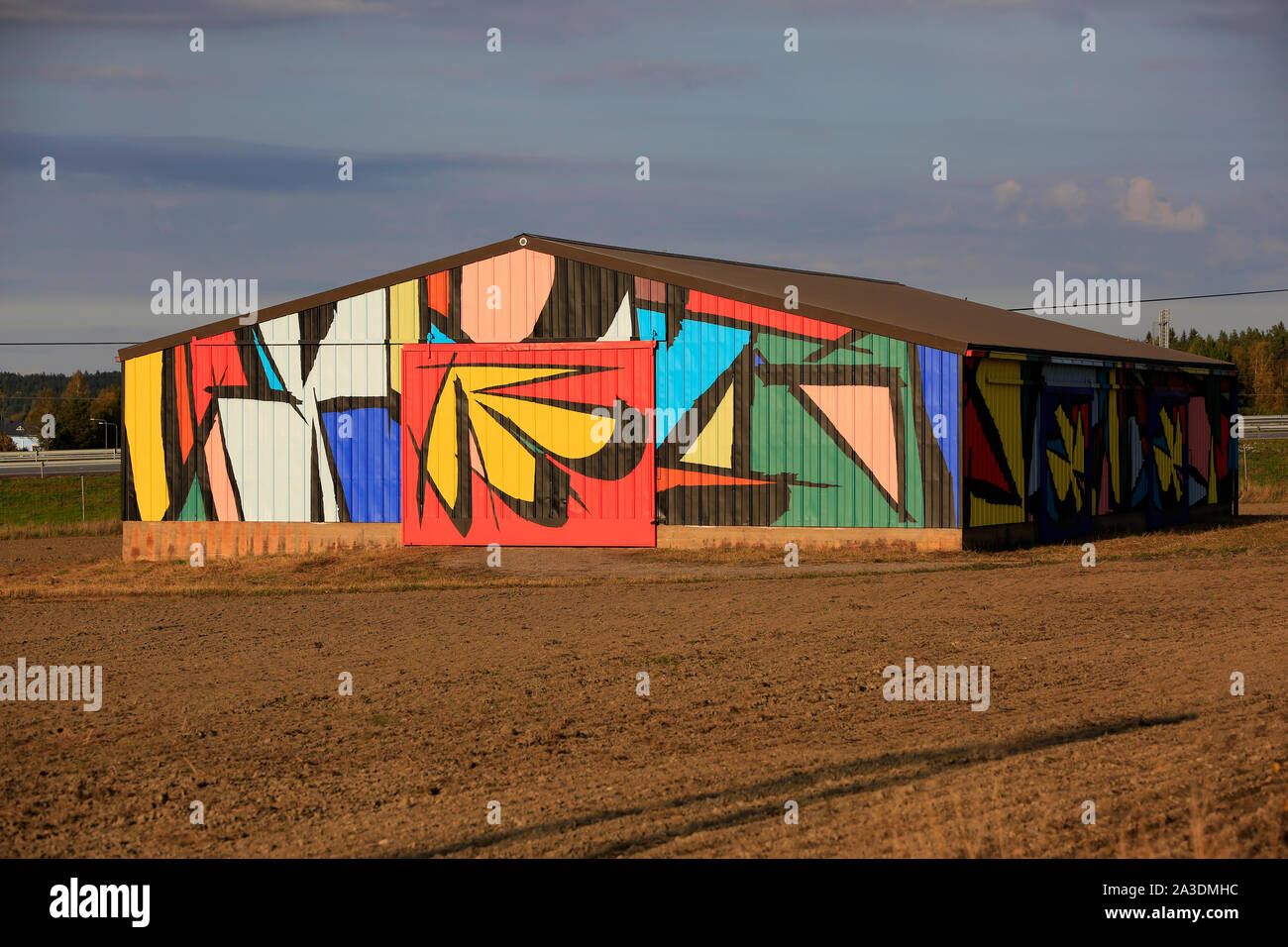 Abstract mural by Sobekcis on a barn in field near the national road 1, E18, in Salo, Finland. The public art project is part of Upeart Festival 2019. Stock Photo