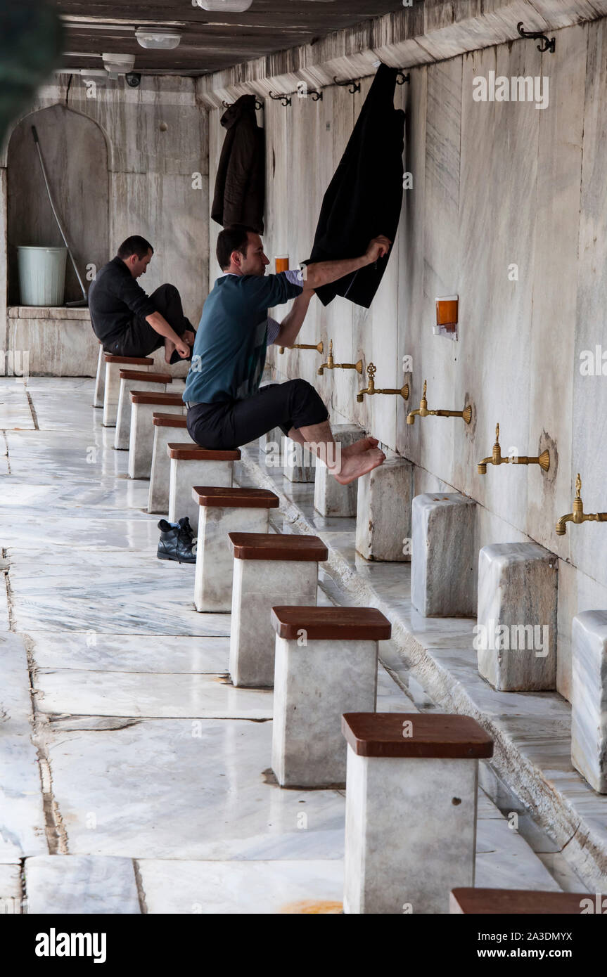 Muslim people wash their feet before entering in mosque in Istanbul