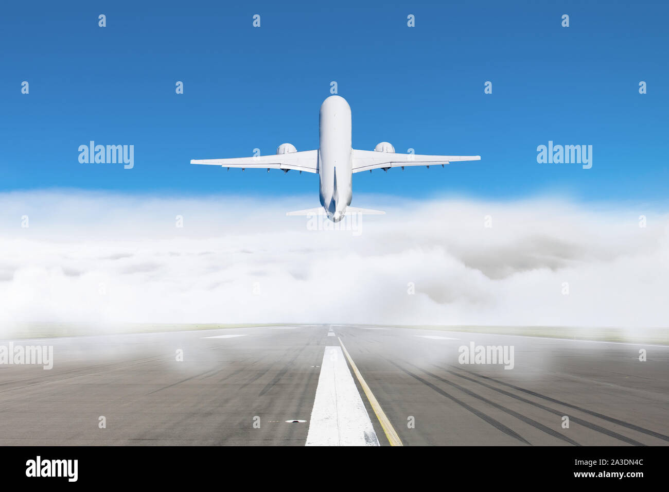 Take-off passenger plane from a cloud of fog at the airport, concept of delayed flights in bad weather Stock Photo