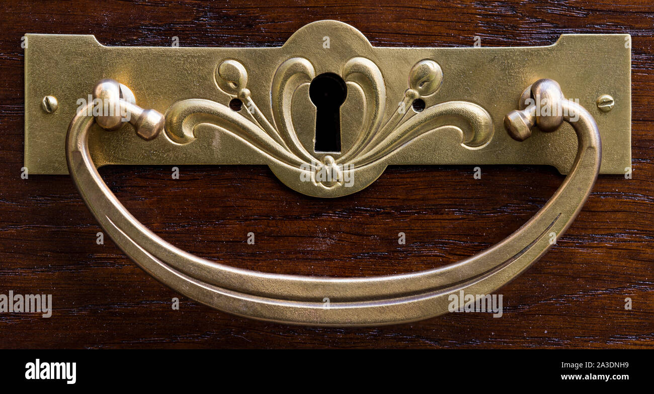 Vintage brass Art Nouveau style handle for furniture. Stock Photo