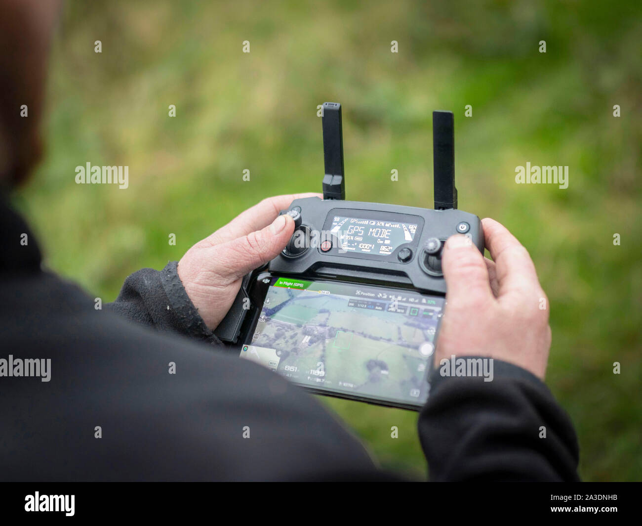 DJI Mavic Pro Platinum Drone controller using iPhone interface young man hobby Stock Photo