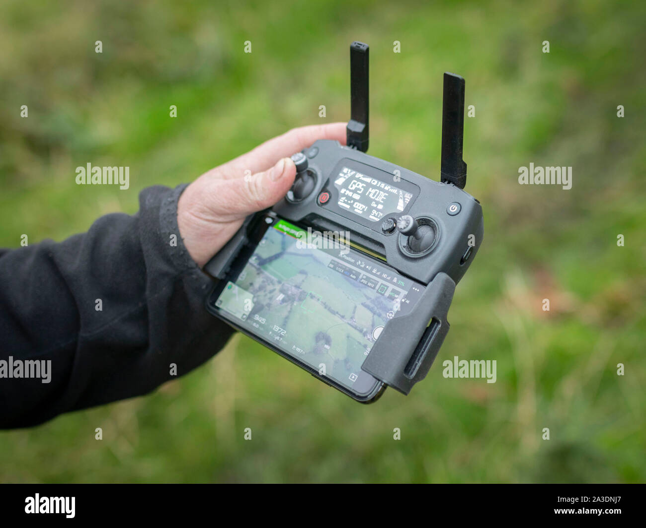 DJI Mavic Pro Platinum Drone controller using iPhone interface young man hobby Stock Photo