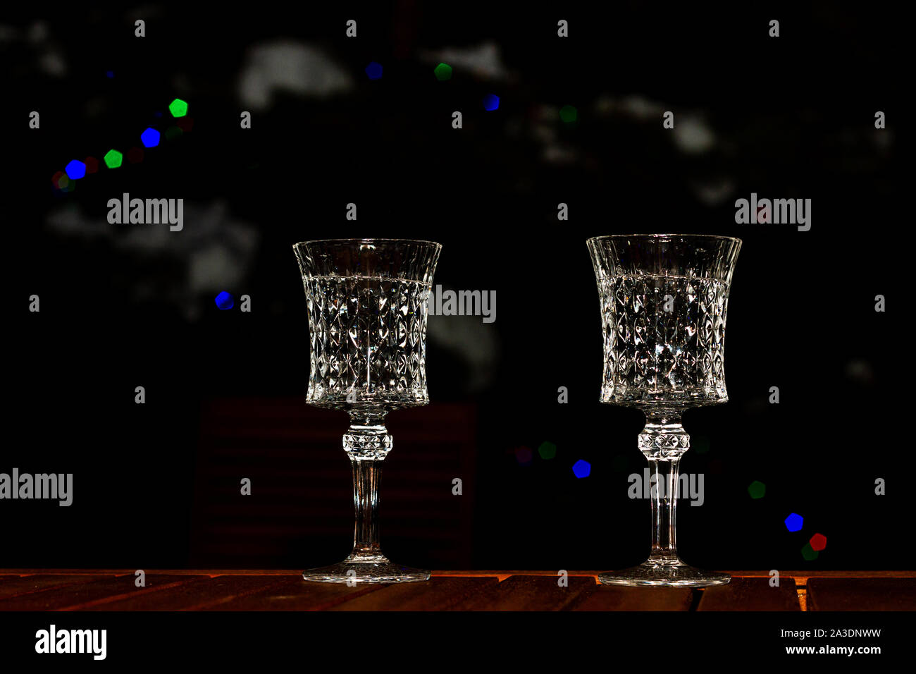 beautiful holiday glasses stand on a table on a dark background Stock Photo