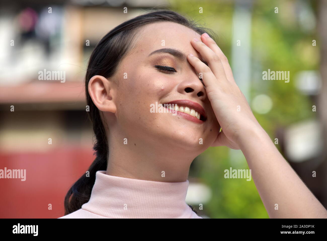 A Laughing Youthful Asian Female Stock Photo