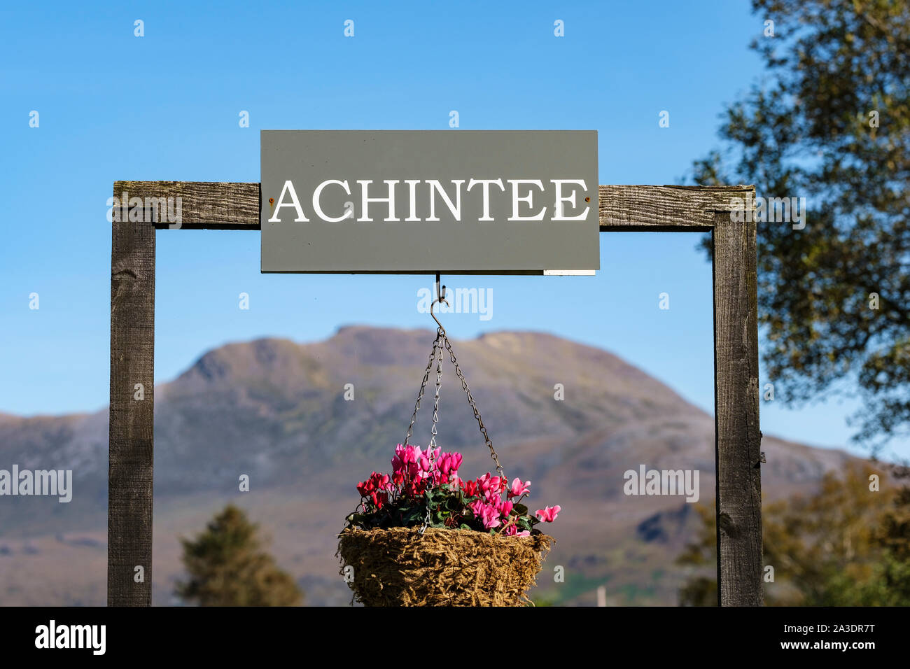 Hamlet place name with hanging basket on A890 Achintee, Strathcarron, Wester Ross, North West Highlands of Scotland Stock Photo