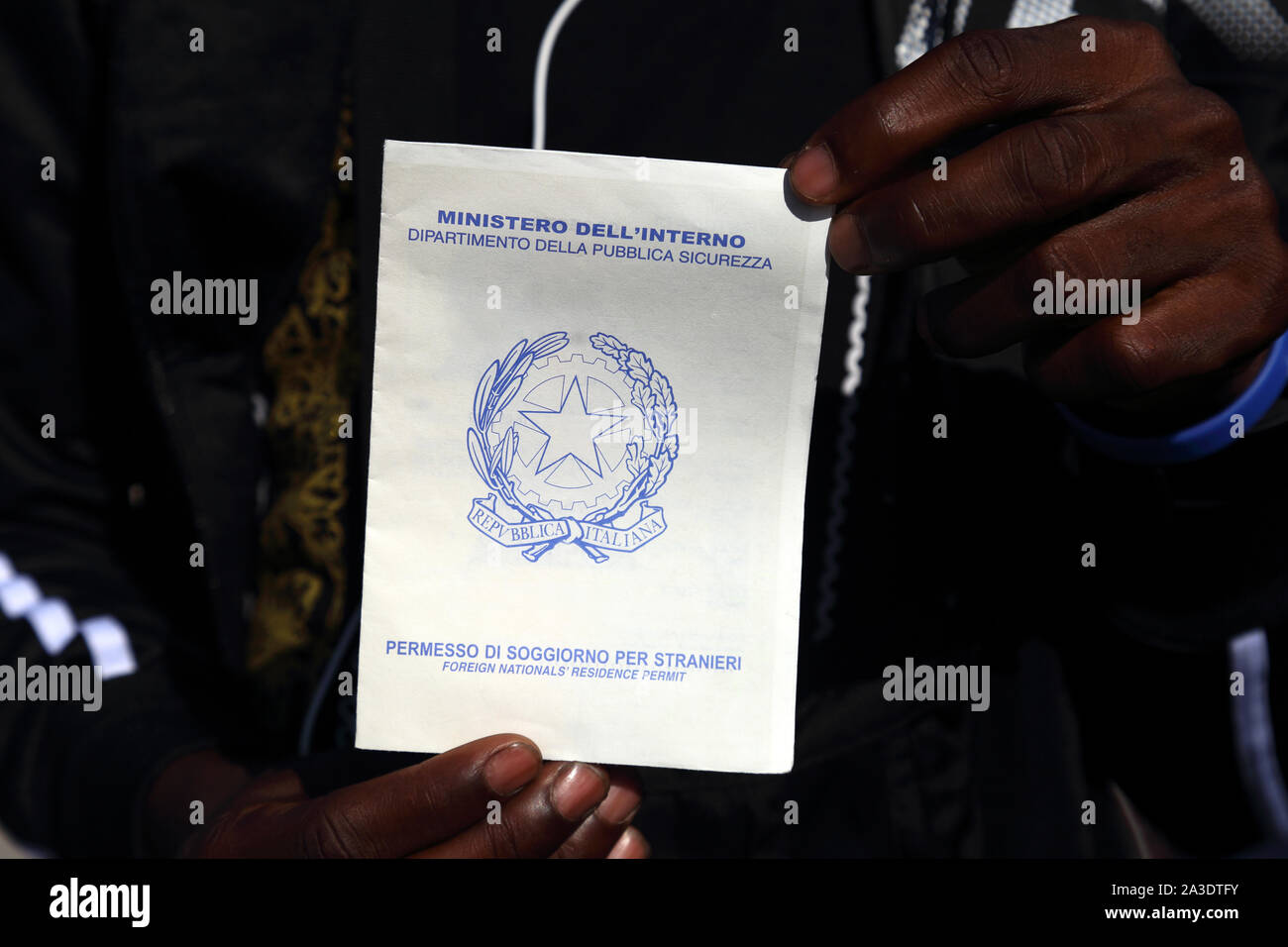 Caserta, Italy - September 27, 2019: A migrant shows his residence permit for foreigners Stock Photo