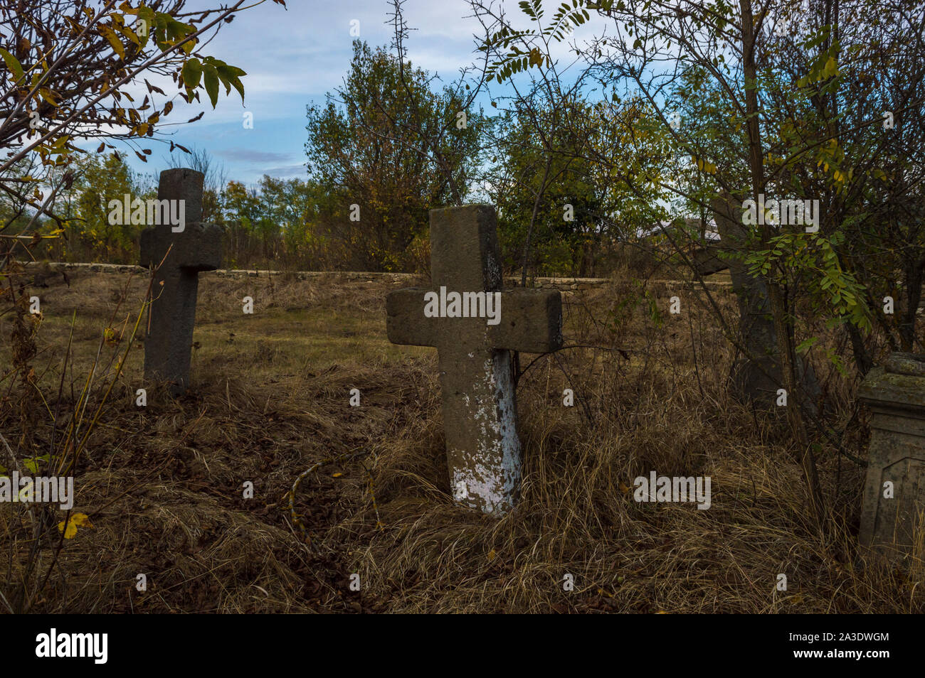 Old Stone Cross Grave Markers on Abandoned Cemetery Stock Photo