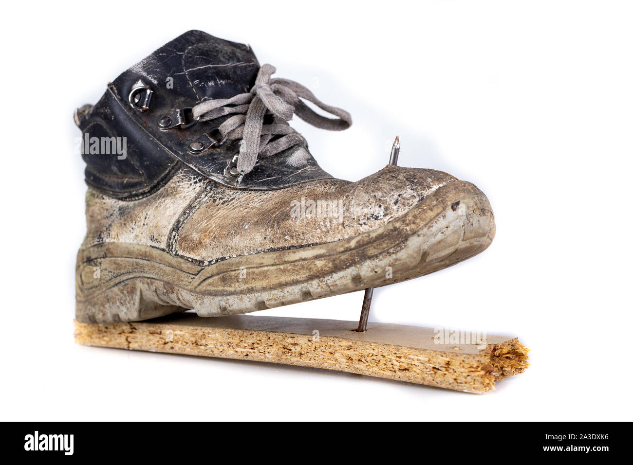 An old work boot with a nail. Construction worker's damaged work