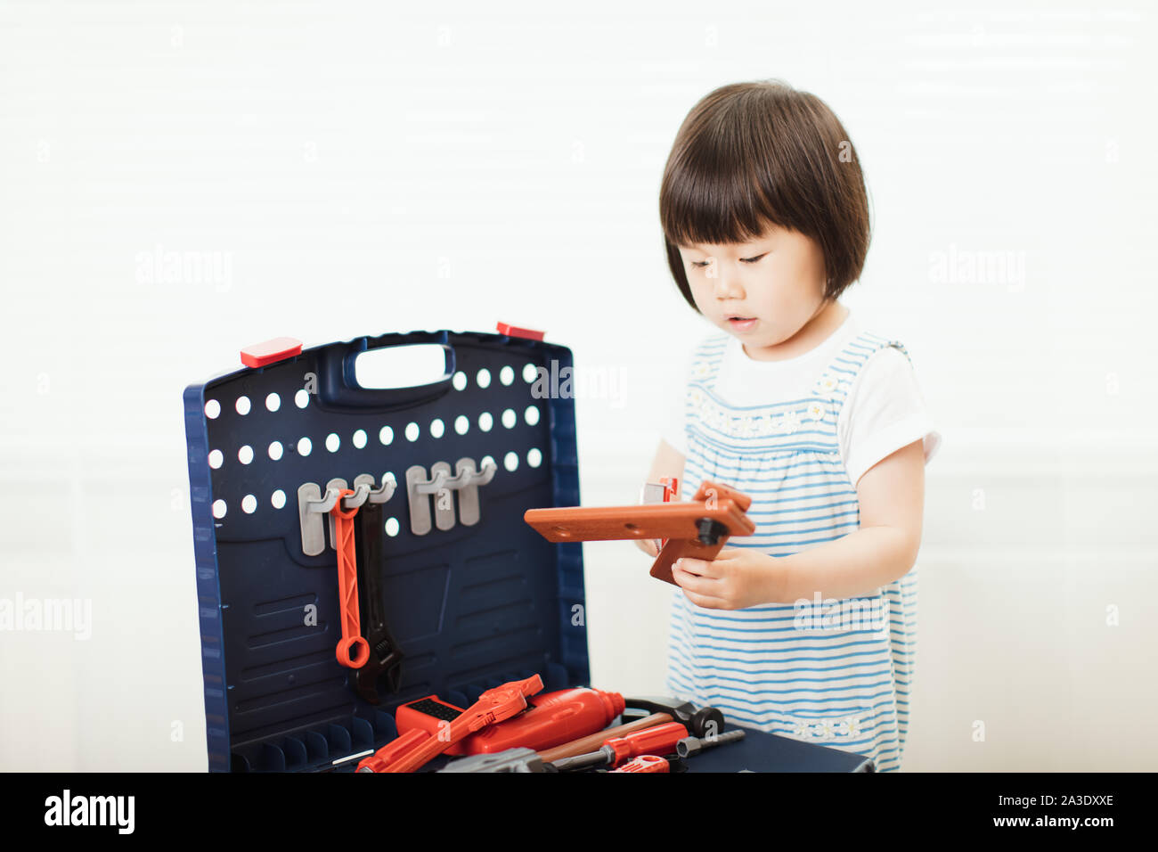 toddler baby girl pretend play DIY tools Stock Photo - Alamy