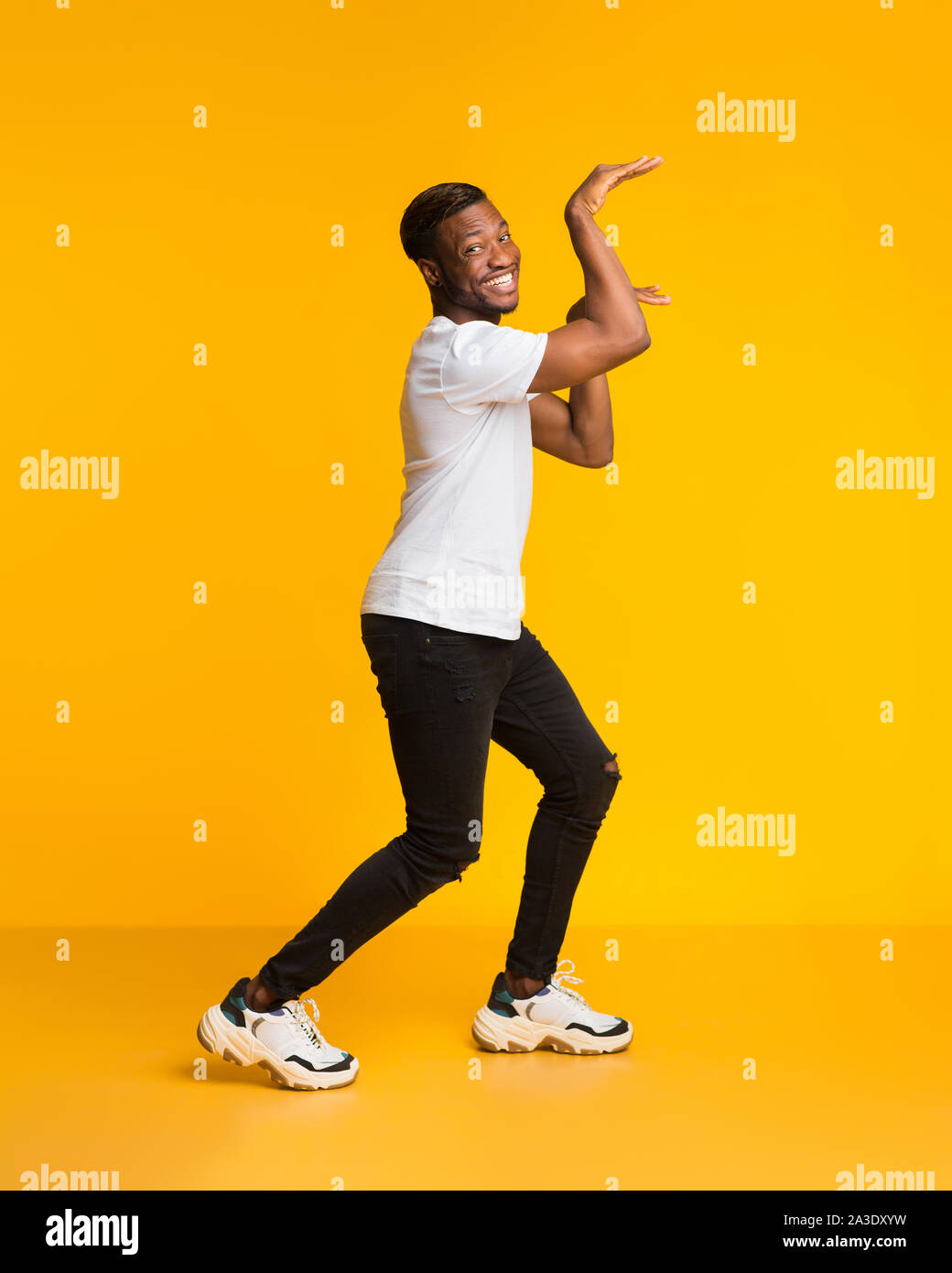 Portrait of one teen funny hipster guy dancing, working out wearing casual  red jeans and beanie. Modern style street young dance Stock Photo - Alamy