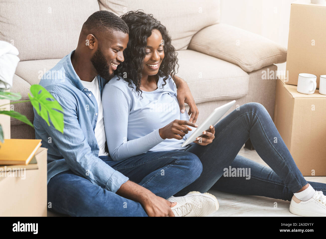 Happy couple using digital tablet for online shopping Stock Photo