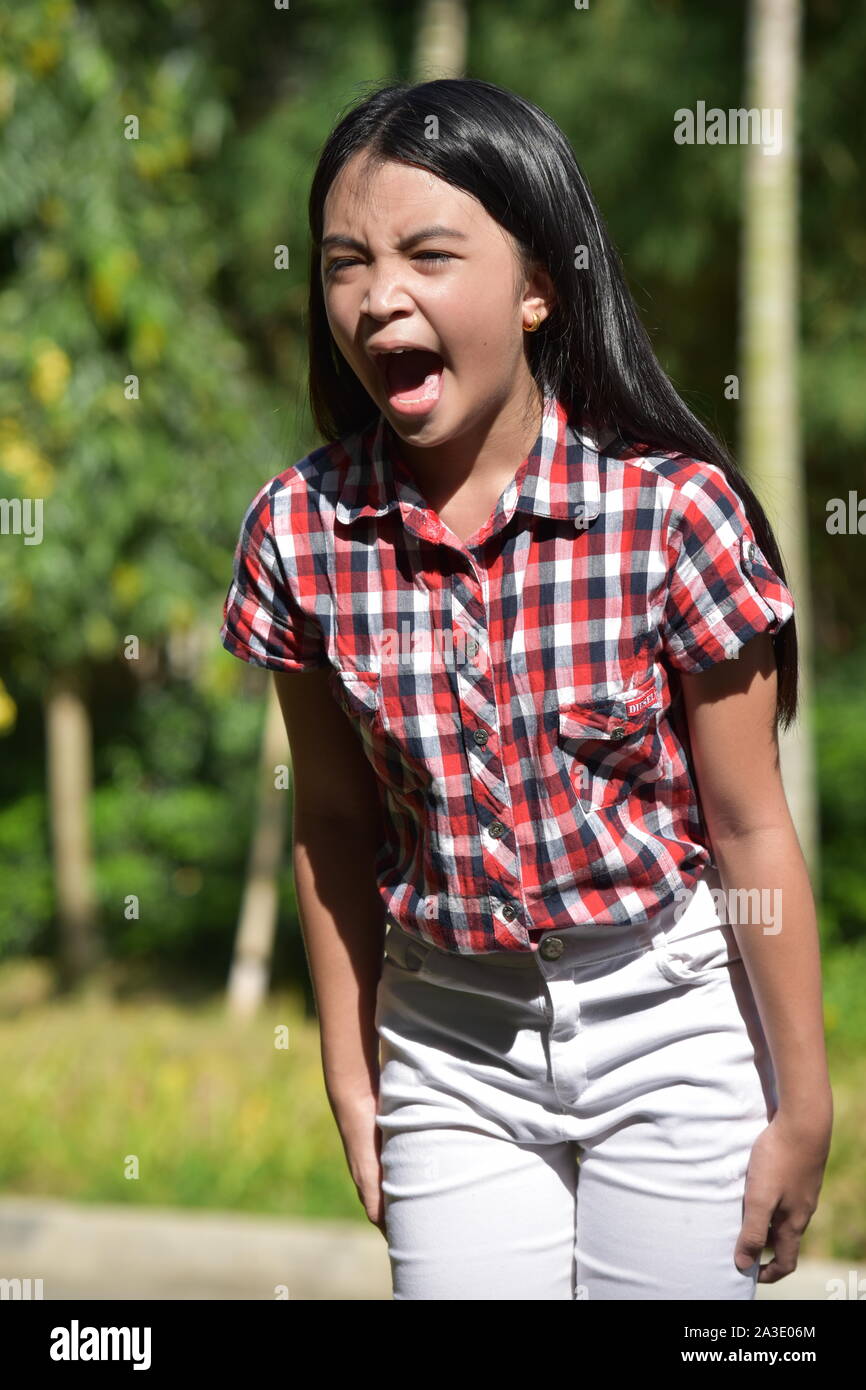 A Beautiful Asian Youth Yelling Stock Photo
