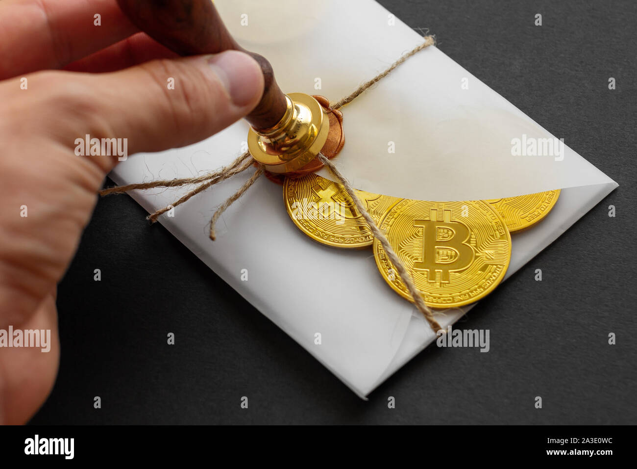 The designed envelope with a golden stamp is used for sending golden bitcoin  coins as a gift. There are big golden BTC cryptocurrency coins in transpa  Stock Photo - Alamy