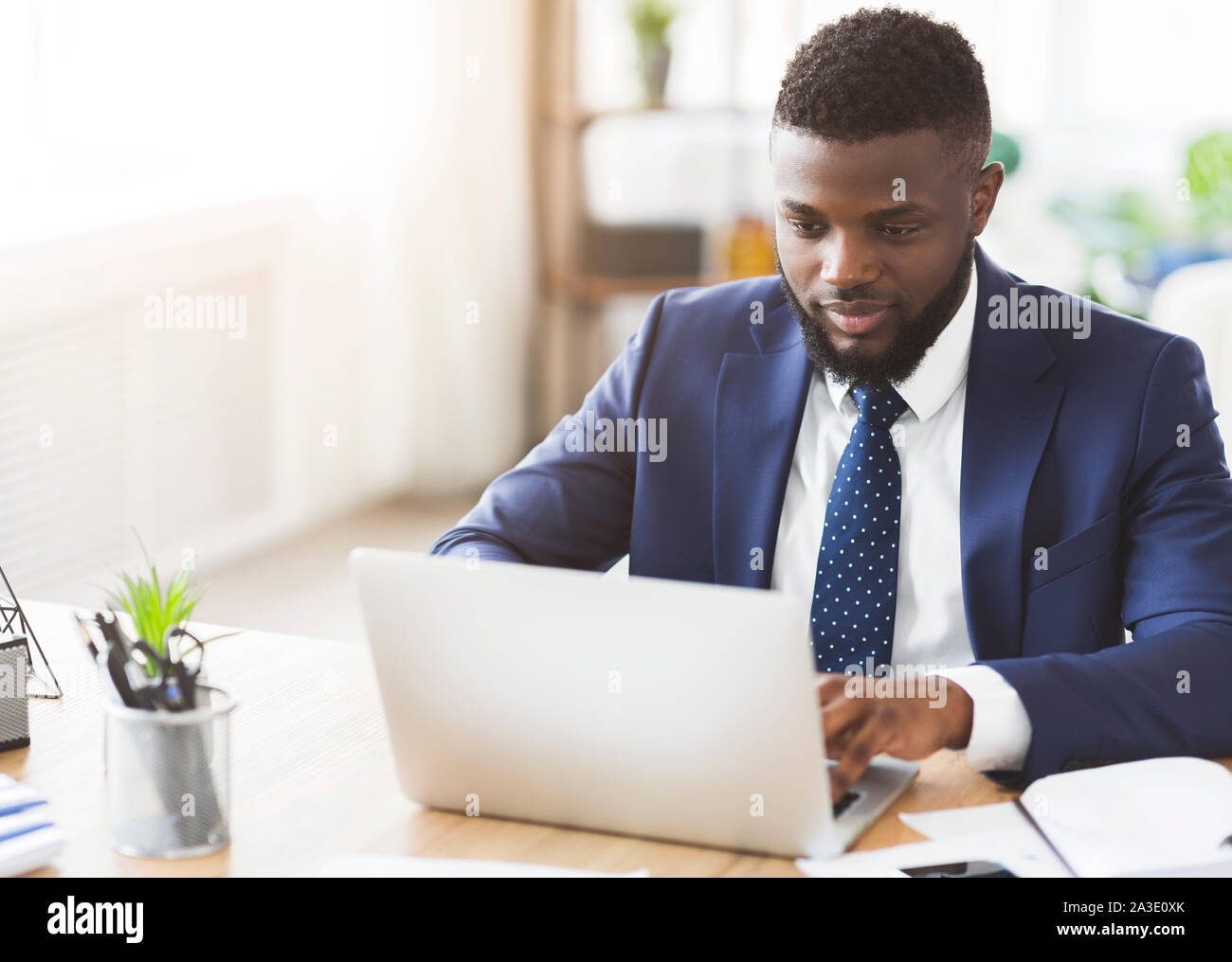 Young businessman working in modern high tech office Stock Photo