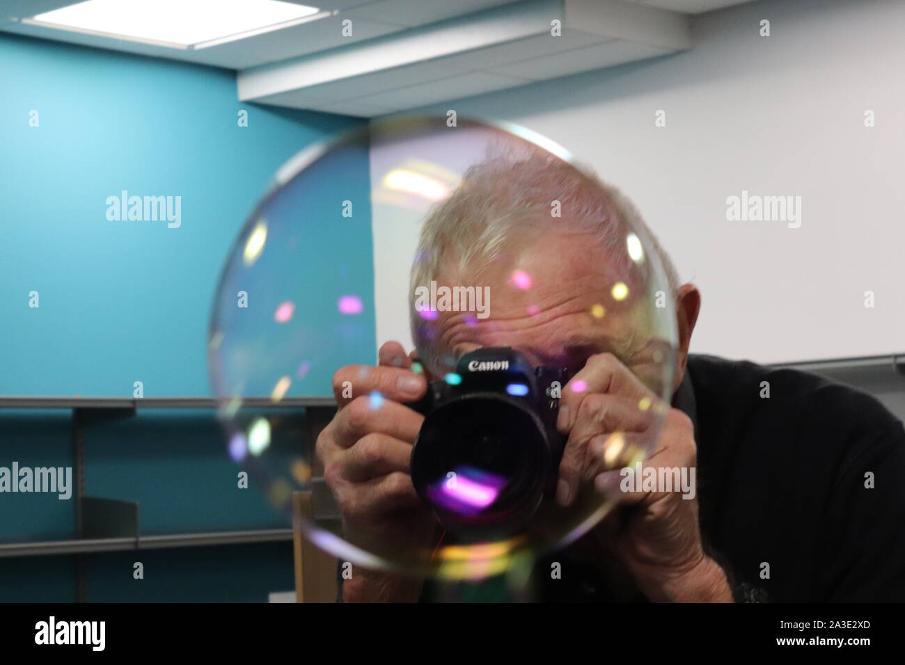 man taking a picture of a bubble Stock Photo