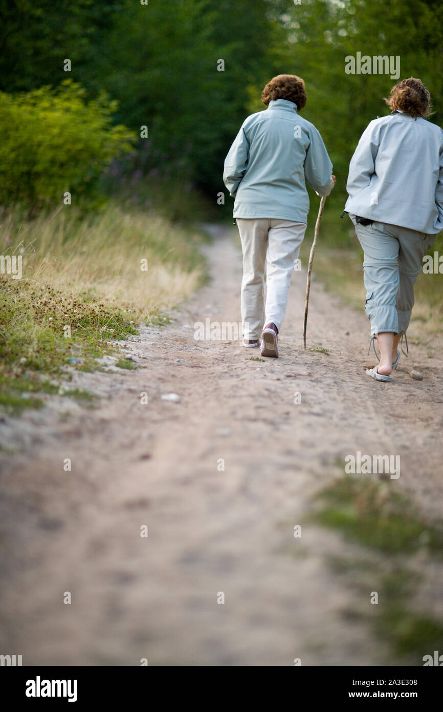 Two woman walking on a beach hi-res stock photography and images - Alamy