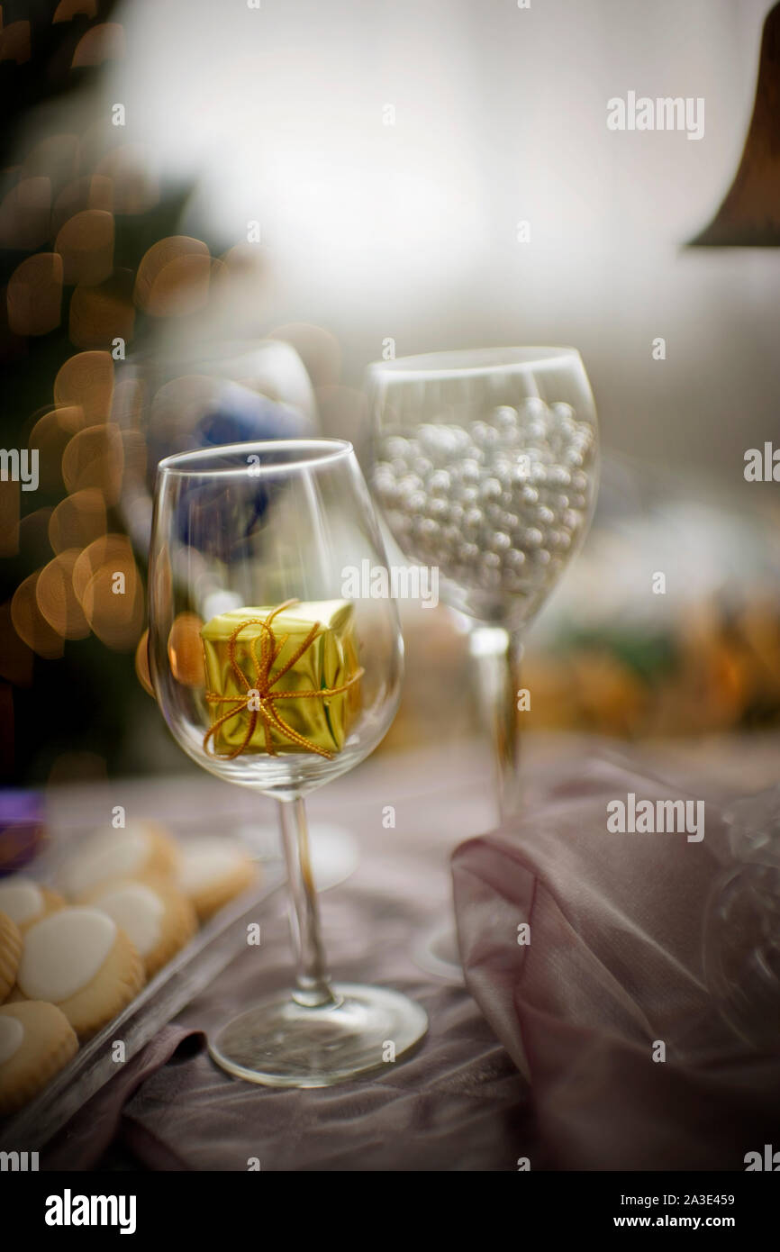 Gift inside an empty wine glass. Stock Photo