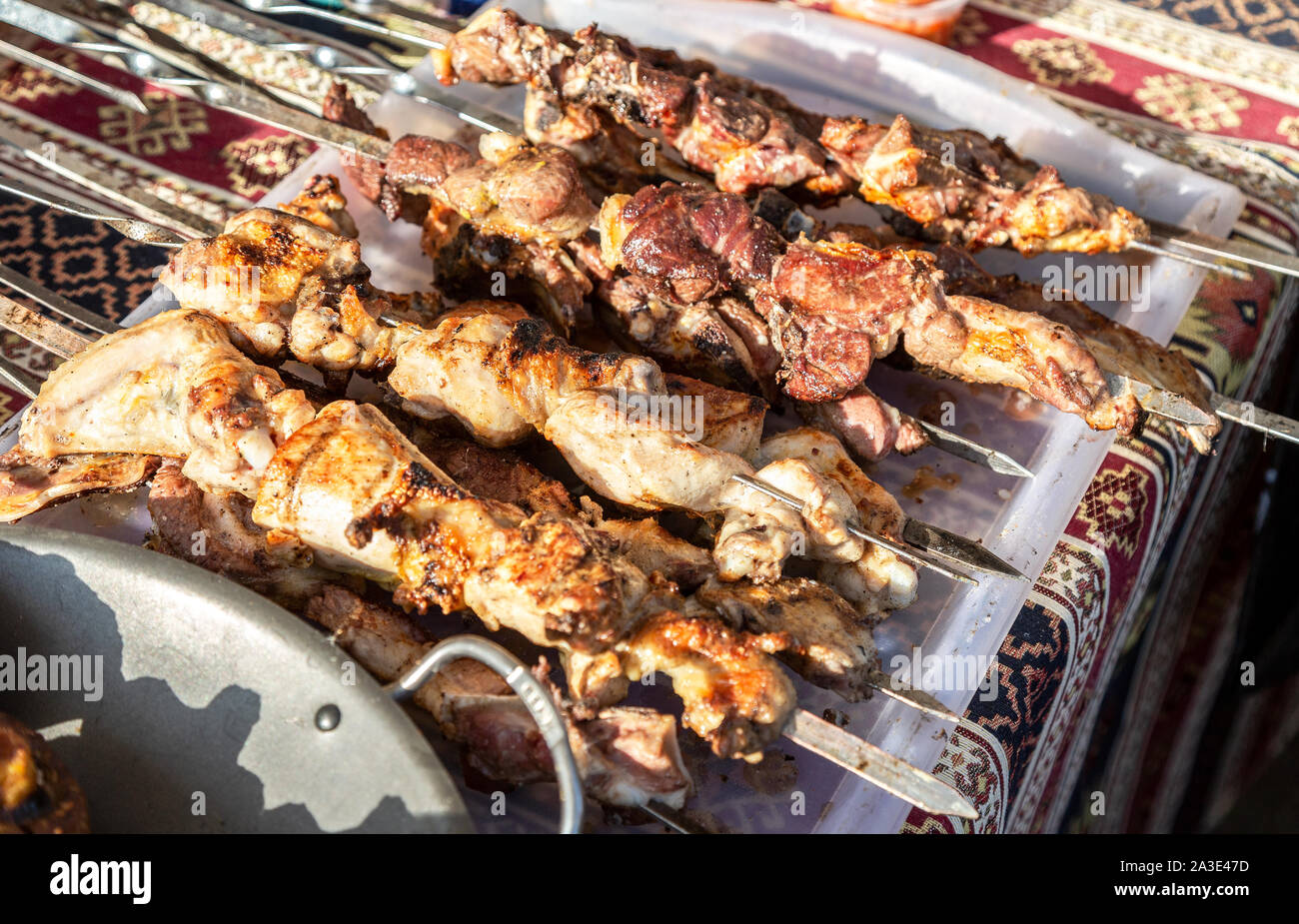 Grilled appetizing kebab on metal skewers. Shashlik made of cubes of