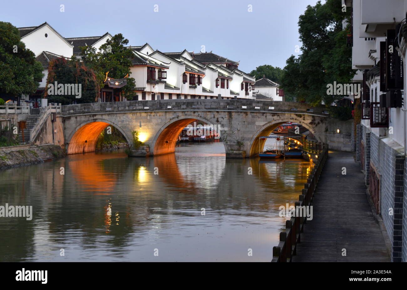 Old Chinese town canal bridge and architecture at dusk, Sanhe, Anhui, China Stock Photo