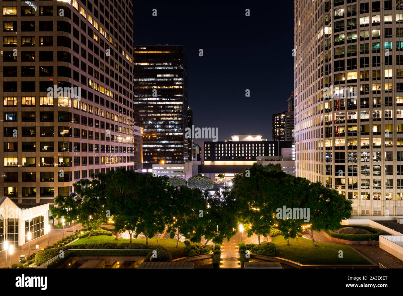 Urban cityscape scene of high rise buildings above a green urban park in downtown Los Angeles, California Stock Photo