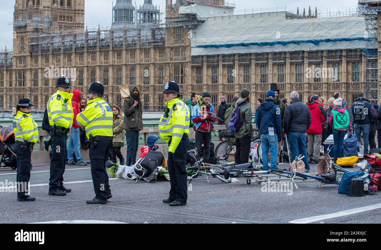 Westminster Bridge, London UK. 7th October 2019. Extinction rebellion climate change activists gather outside St Thomas' Hospital and Westminster bridge creating traffic disruption on major roads around Westminster.  This was the first day of protests which are planned accross London for the next fortnight to raise awareness of global climate change.  Celia McMahon/Alamy Live News. Credit: Celia McMahon/Alamy Live News Stock Photo