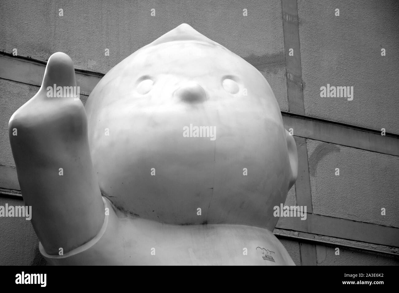 Bangkok, Thailand 08.23.2019: A giant white colored boy statue points towards the sky with his right hand and staring at infinity in front of the entr Stock Photo