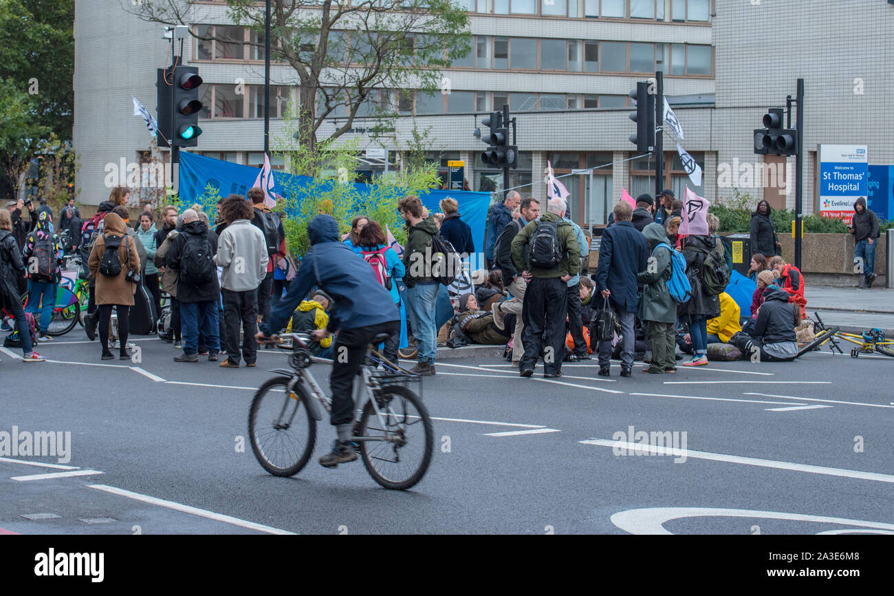 Westminster Bridge, London UK. 7th October 2019. Extinction rebellion climate change activists gather outside St Thomas' Hospital and Westminster bridge creating traffic disruption on major roads around Westminster.  This was the first day of protests which are planned accross London for the next fortnight to raise awareness of global climate change.  Celia McMahon/Alamy Live News. Credit: Celia McMahon/Alamy Live News Stock Photo