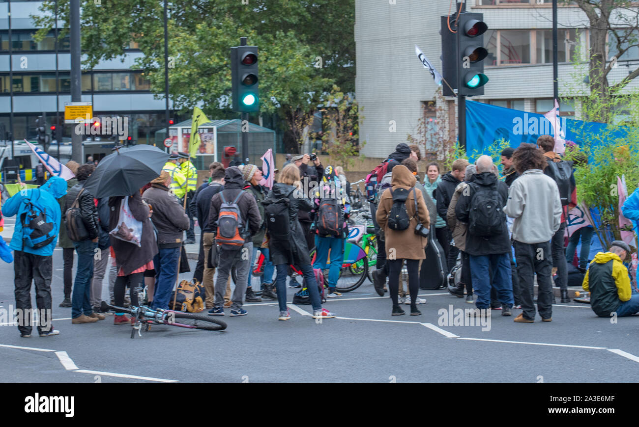 Westminster Bridge, London UK. 7th October 2019. Extinction rebellion climate change activists gather outside St Thomas' Hospital and Westminster bridge creating traffic disruption on major roads around Westminster.  This was the first day of protests which are planned accross London for the next fortnight to raise awareness of global climate change.  Celia McMahon/Alamy Live News. Credit: Celia McMahon/Alamy Live News Stock Photo