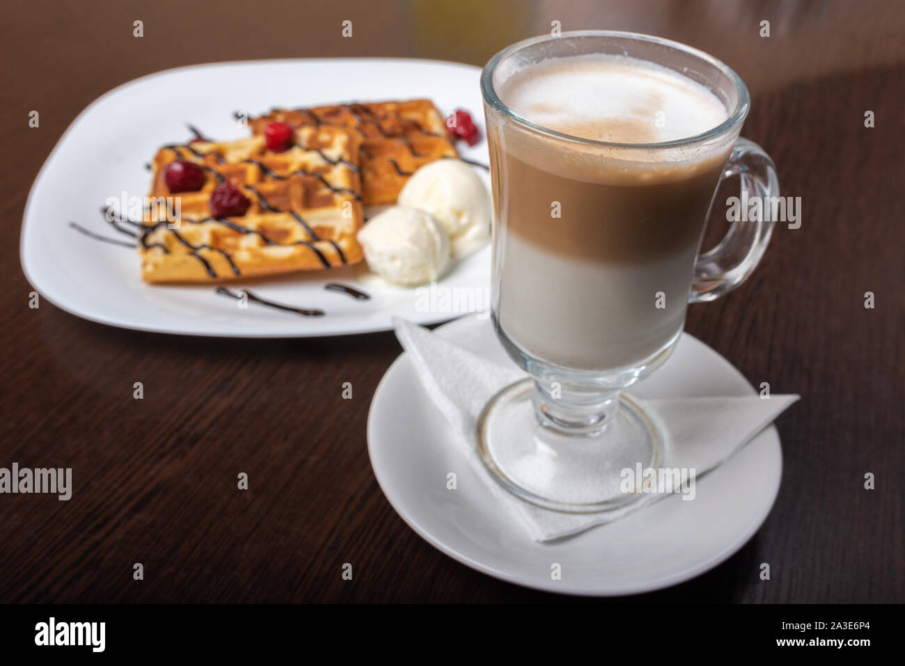Viennese waffles with latte coffee, on a wooden table. Stock Photo