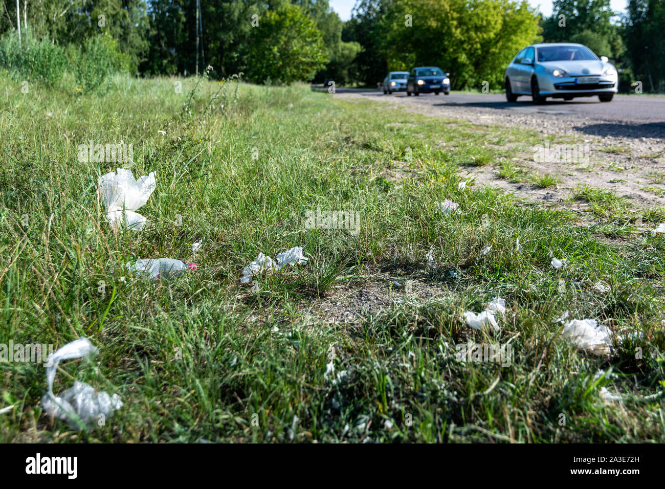 Garbage is scattered on the side of the road Stock Photo - Alamy
